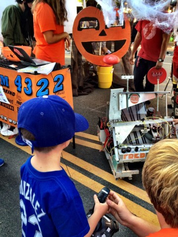 A child using a controller to shoot a Frisbee through the Jack-O-Lantern - source Mr. Bowie